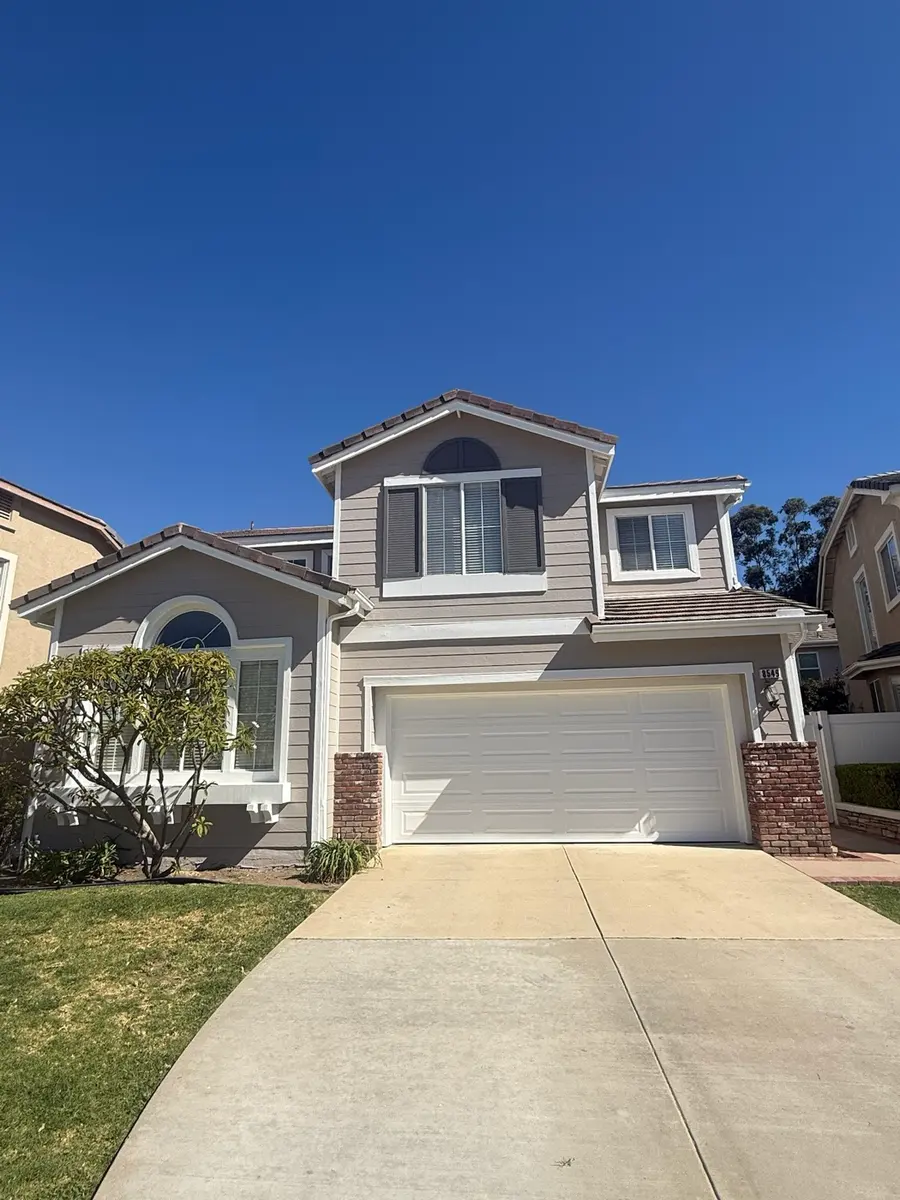 Two storey exterior in warm grey with white trim