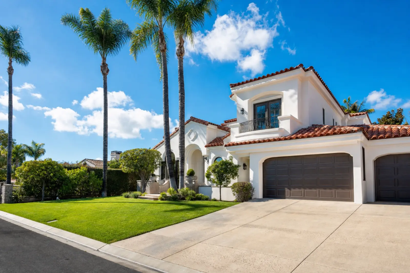 Freshly painted Spanish style home with palm trees in Orange County