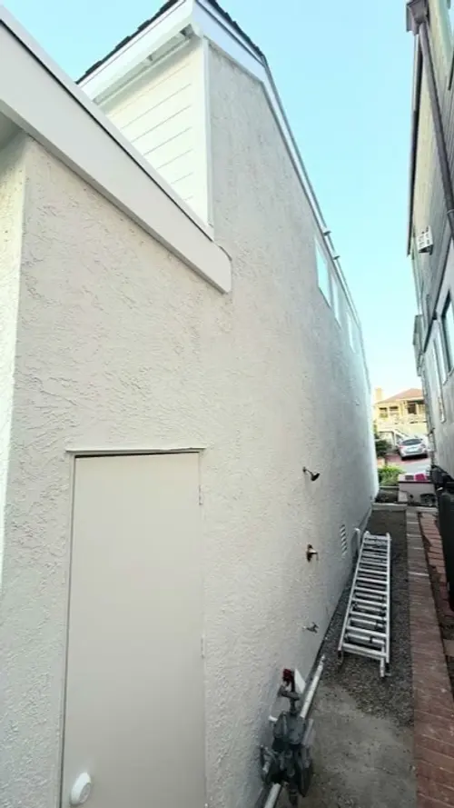 Exterior Painting by Brush & Beyond Paint in Laguna Beach, CA. Coastal side elevation, fresh stucco coat.